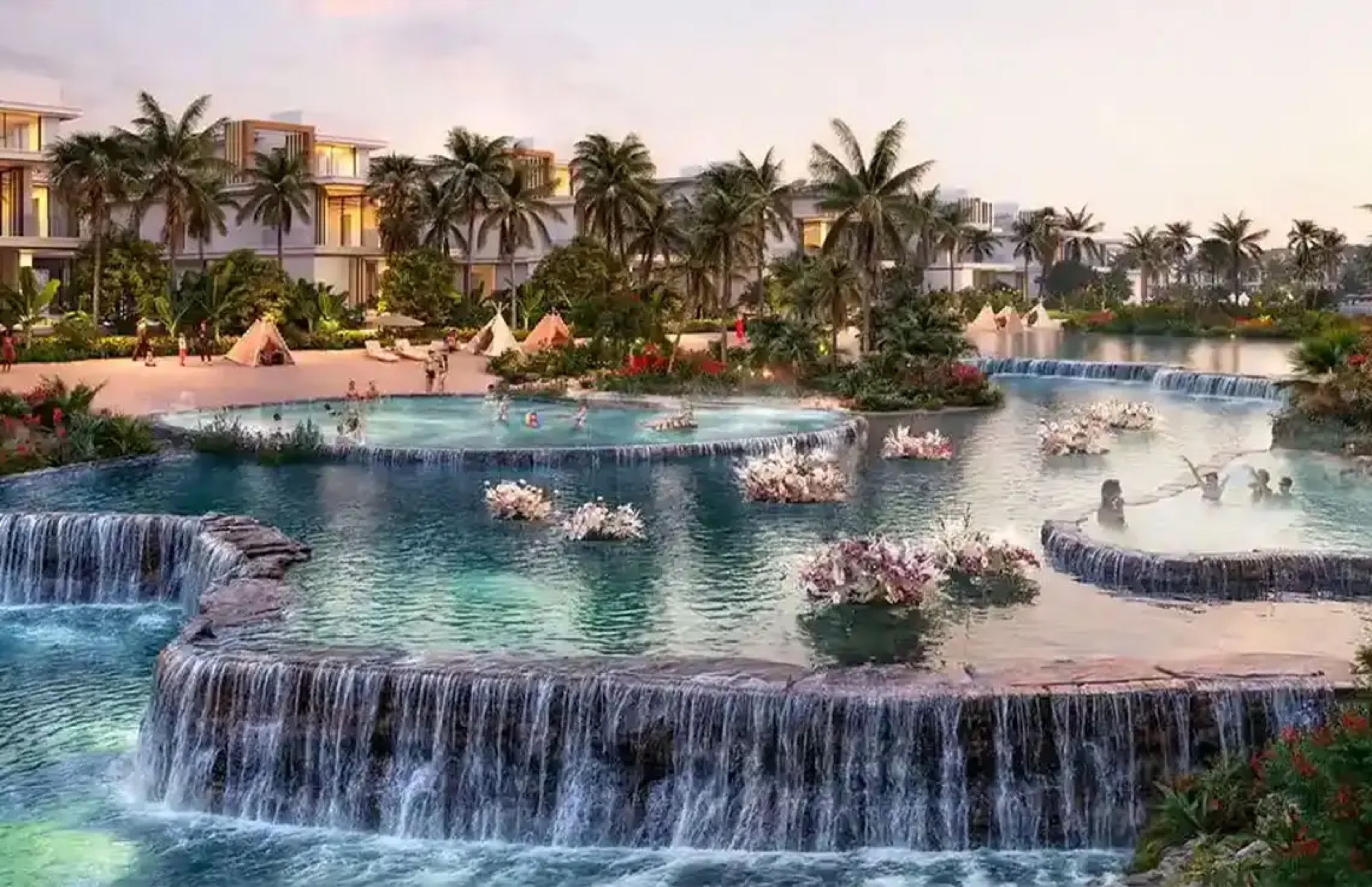 DAMAC Islands 2 Dubai waterfall lagoon at golden hour — palm-lined villas, tipi pavilions and tropical landscaping