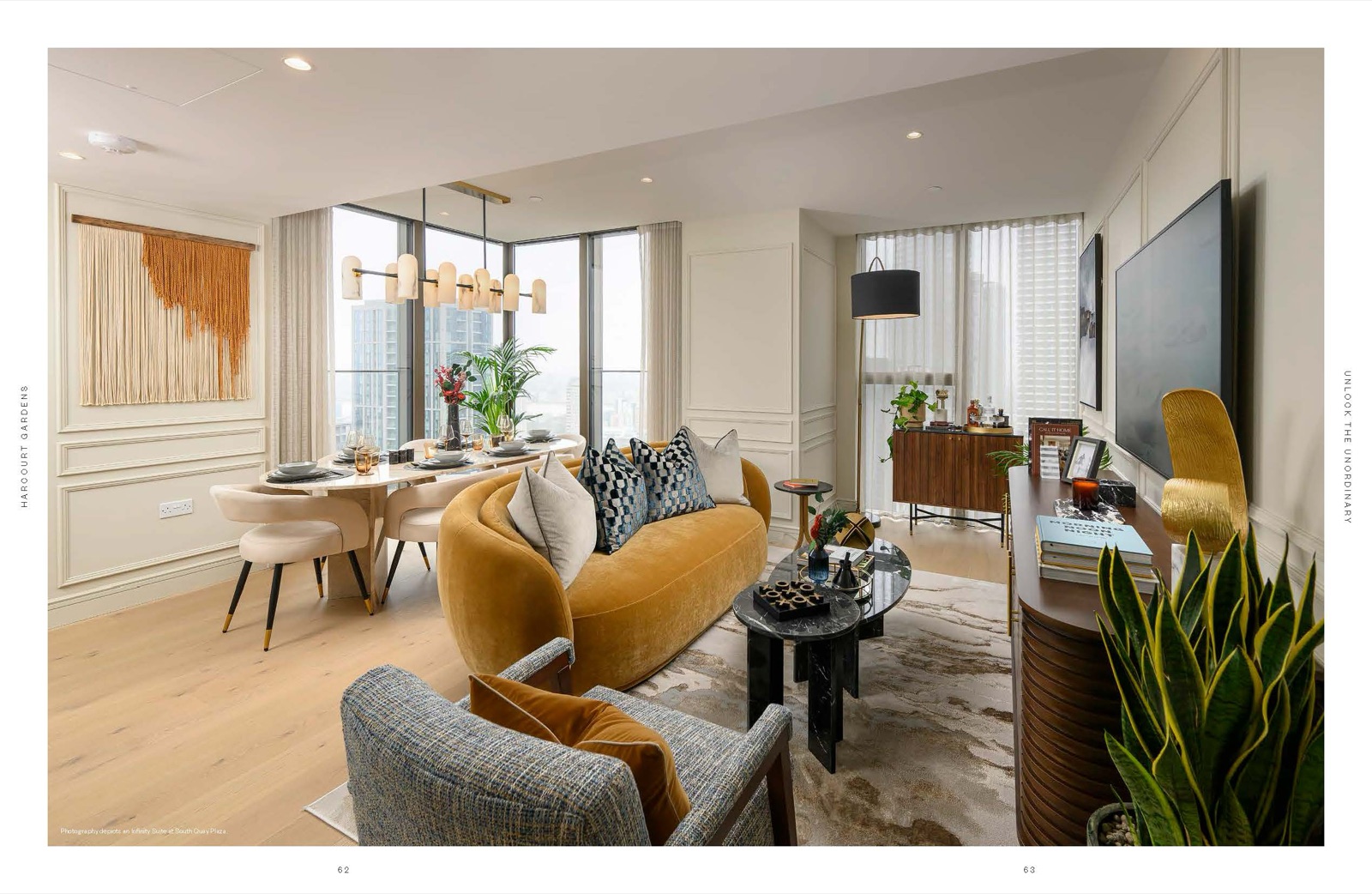 Harcourt Gardens South Quay Plaza Canary Wharf E14 show-home Infinity Suite living and dining room with curved mustard velvet sofa, walnut sideboard and Canary Wharf skyline