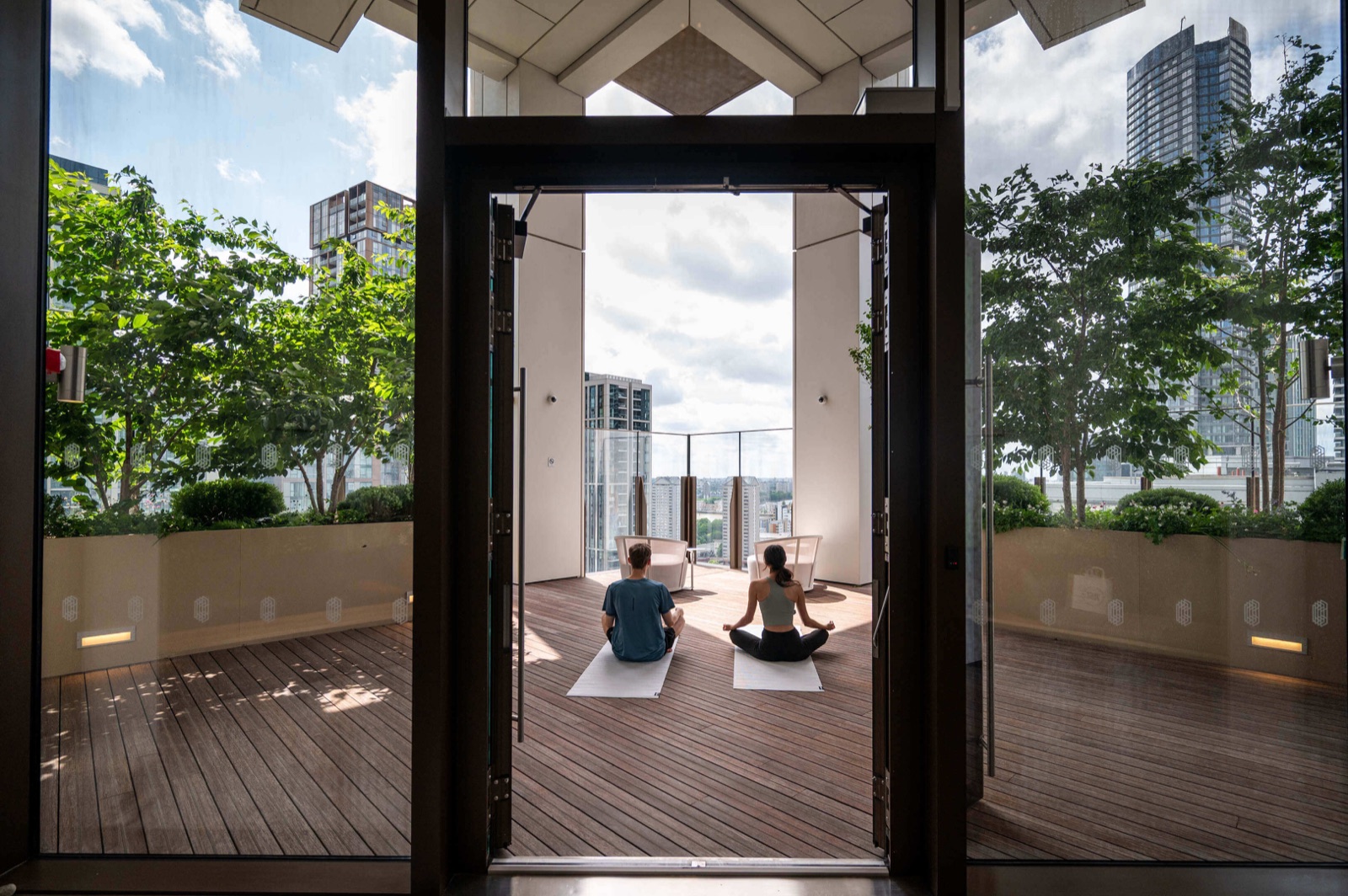 Harcourt Gardens South Quay Plaza Canary Wharf E14 yoga and meditation studio with rooftop terrace doors open onto the Canary Wharf skyline at The Quay Club