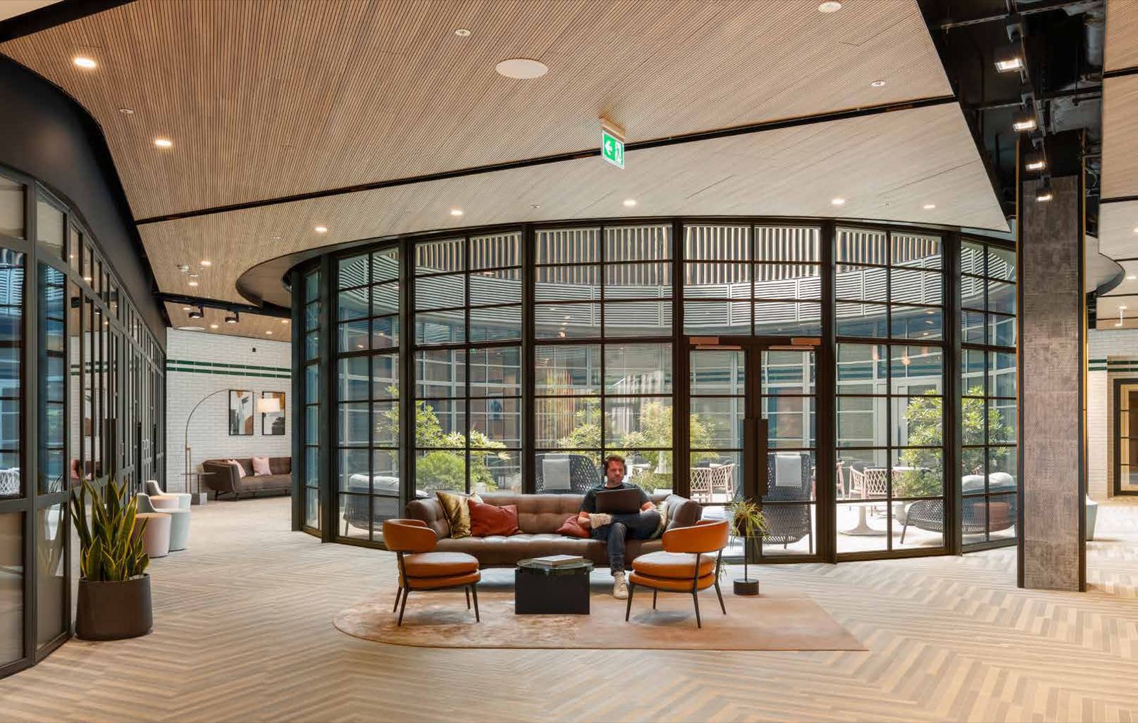 One King's Road Park Fulham SW6 London Atrium residents' lounge with herringbone floors, glass-walled garden room and EPR-designed central social space