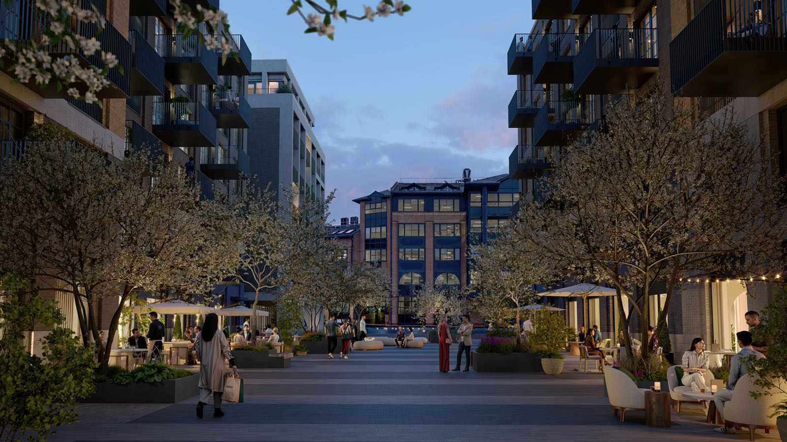 Ransome's Wharf Battersea SW11 London pedestrianised streetscape at dusk with blossom trees and festoon lighting