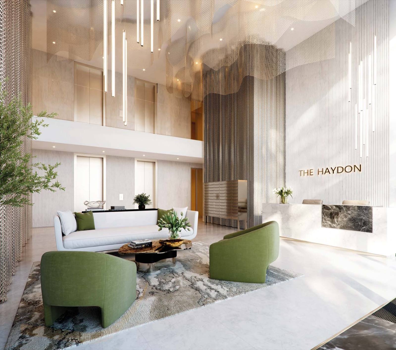 The Haydon Aldgate City of London double-height lobby with THE HAYDON signage and green seating