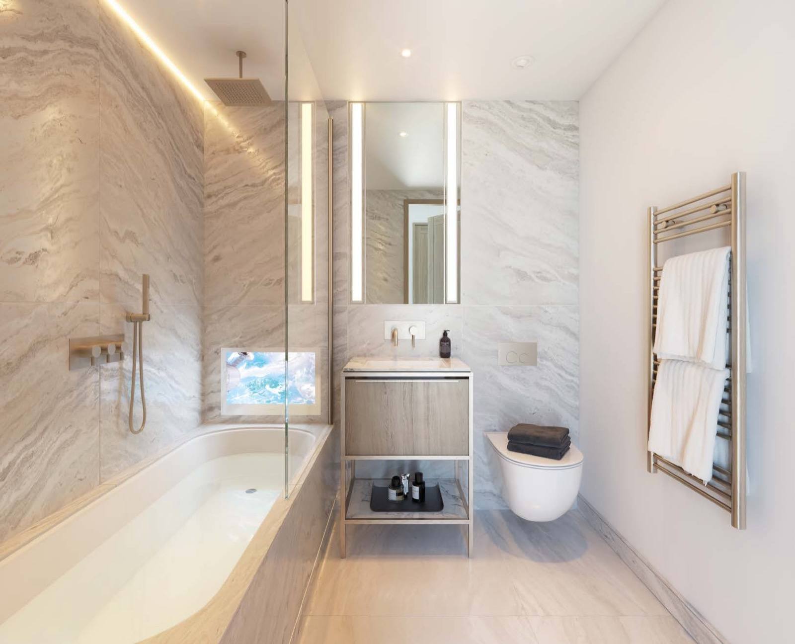 The Haydon Aldgate EC3 London apartment bathroom in travertine marble with walk-in shower and sunken bath